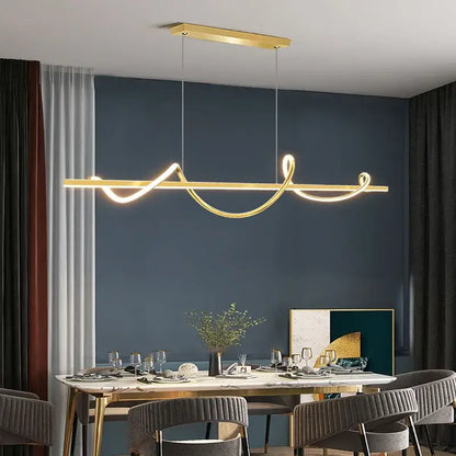 Gold-colored DecorBites LED chandelier pendant light with sleek curved strips suspended above a dining table