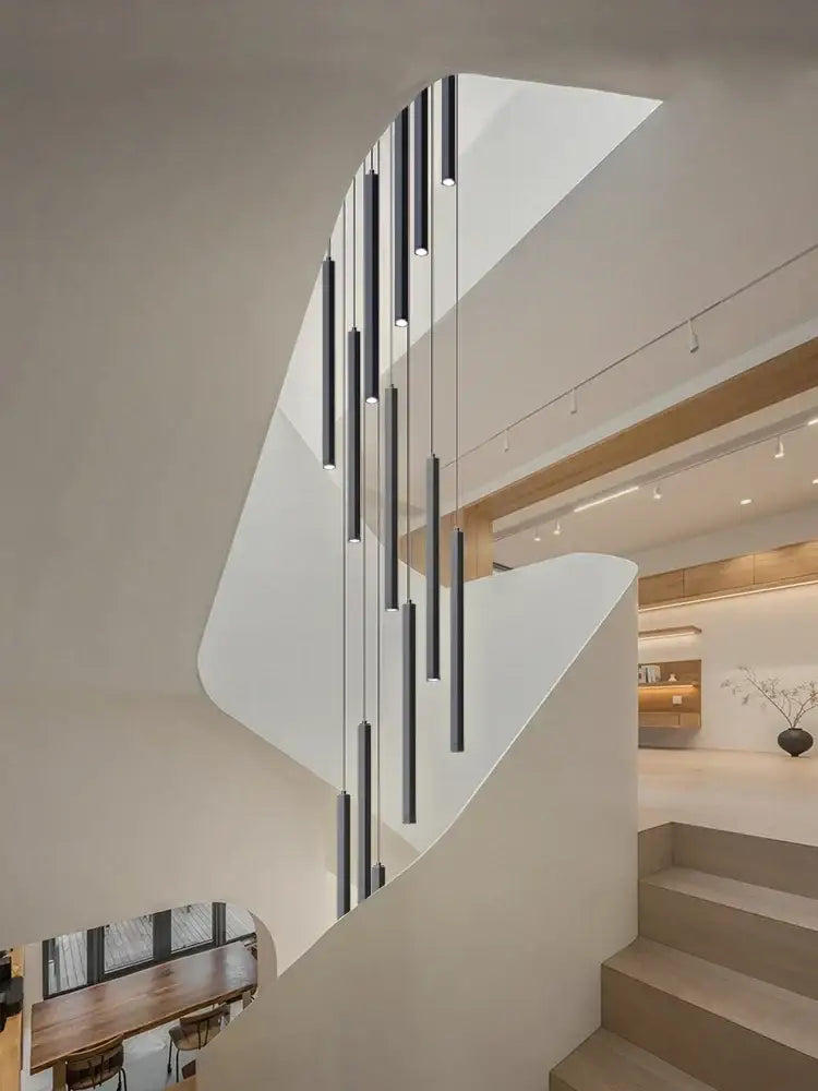 Modern minimalist decorbites led chandelier with sleek black cylindrical shades cascading for hotel lobby decor