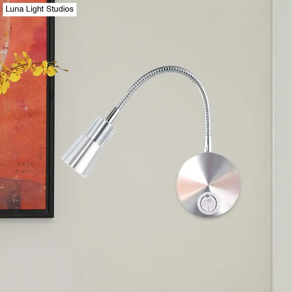Silver metallic wall-mounted reading lamp with flexible gooseneck and adjustable mini metal shade for bedroom use