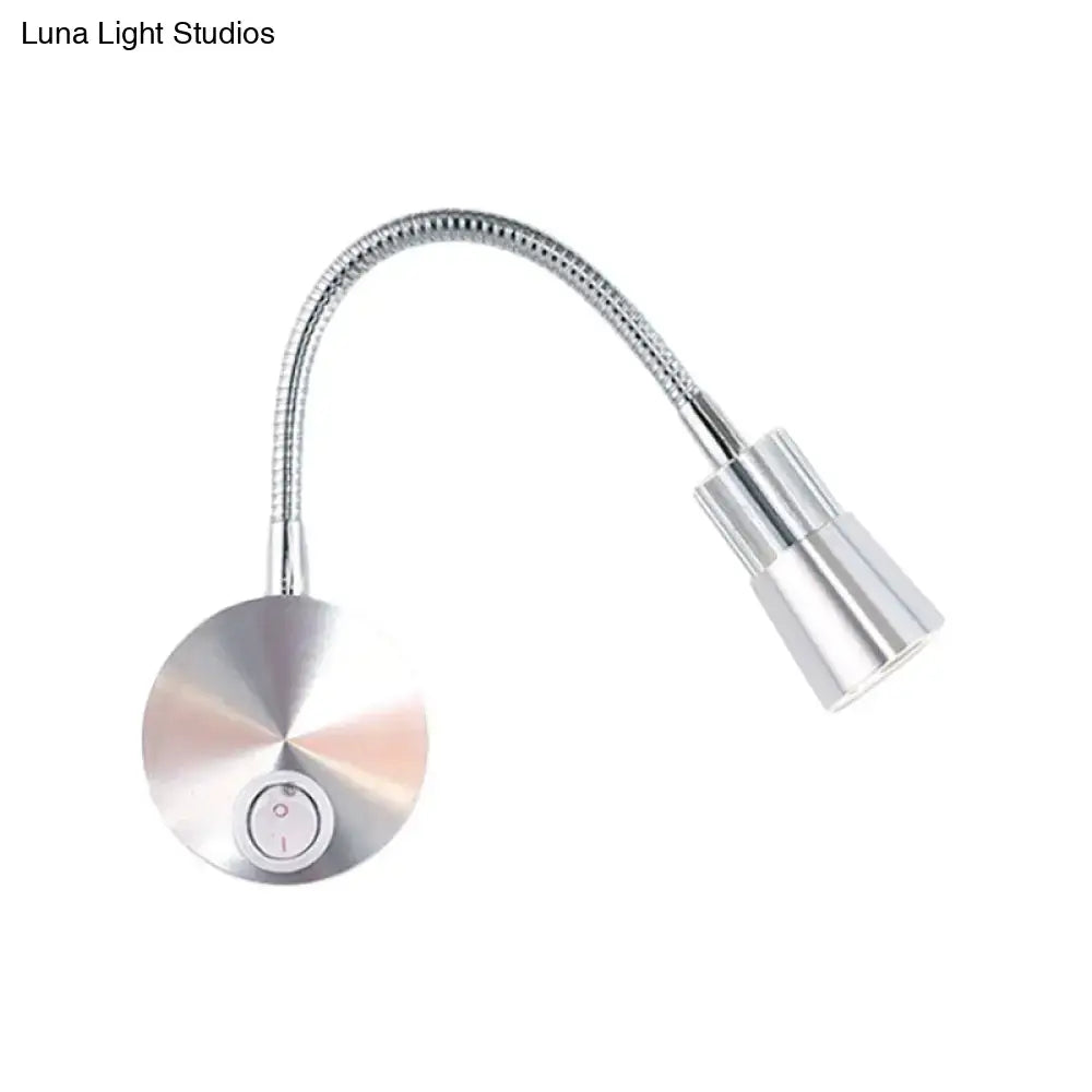 Silver metallic gooseneck reading lamp with chrome flexible arm and mini metal shade for bedroom use