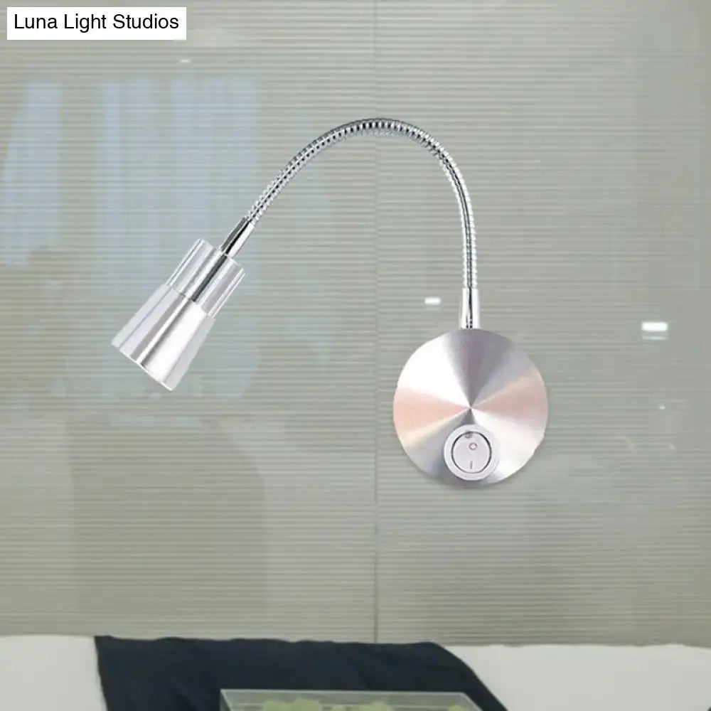 Silver metallic wall-mounted reading lamp with flexible gooseneck and adjustable mini metal shade for bedroom use