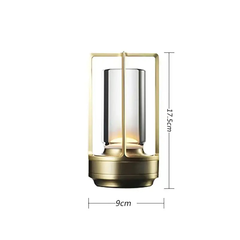 A sleek brass-finished decorbites™ led crystal table lamp with cylindrical glass and warm led lighting for bedside use