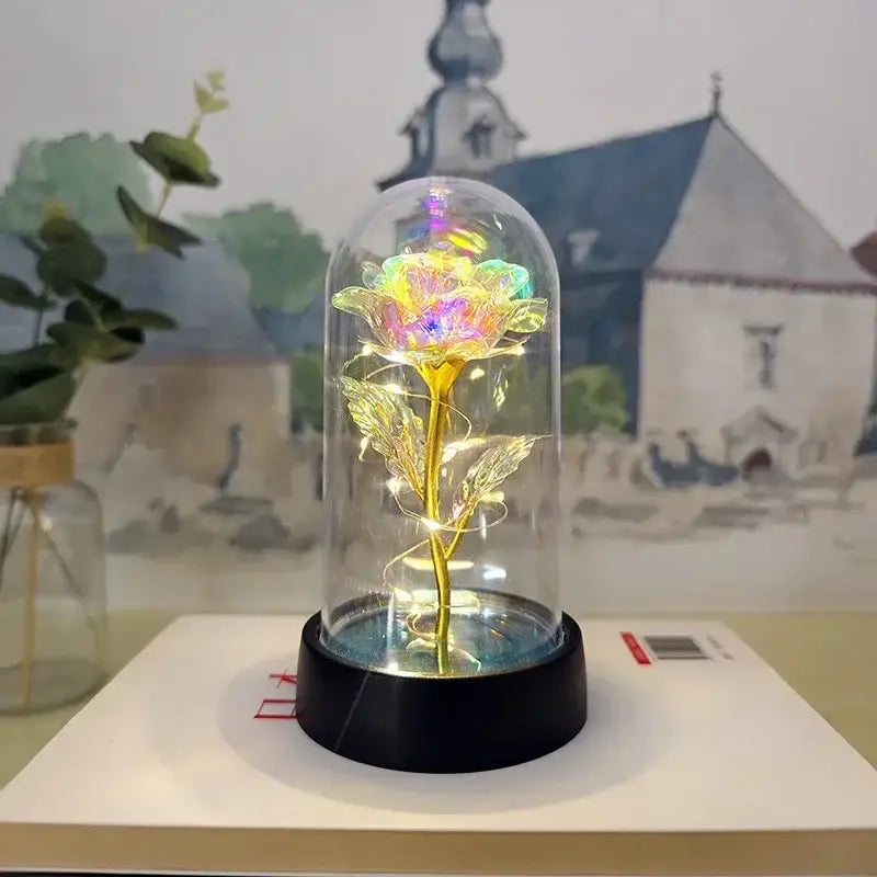 DecorBites™ LED eternal rose light features a glowing golden rose with rainbow led lights in a glass dome for weddings