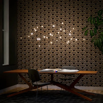 A modern wooden table with a sleek x-shaped base complements the decorbites™ led firefly chandelier engineering minimal design