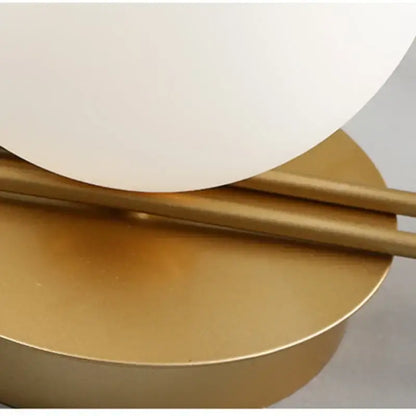 Modern gold-toned decorbites led g9 wall sconce with smooth opaque white spherical glass shade for minimalist lighting