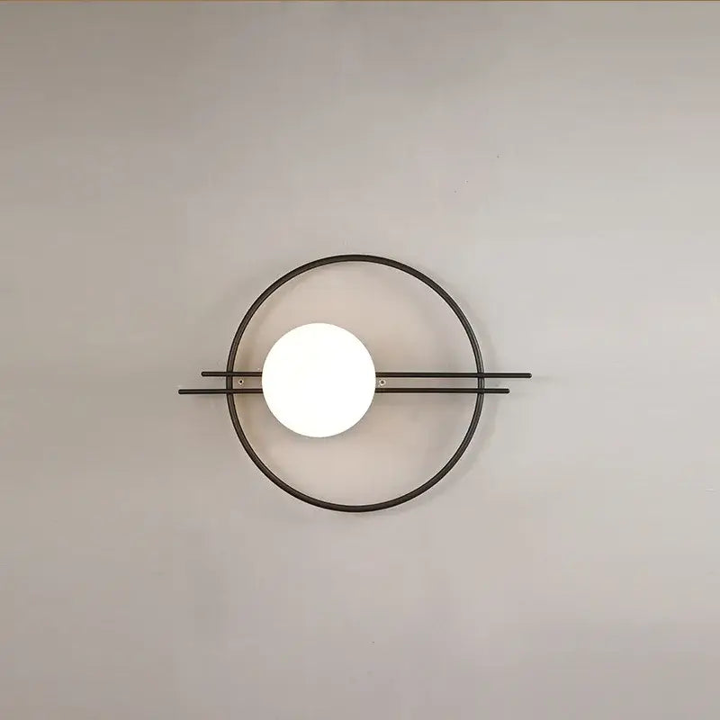 Minimalist black metal DecorBites led G9 wall sconce with a glowing white spherical bulb for living room and bedroom lighting