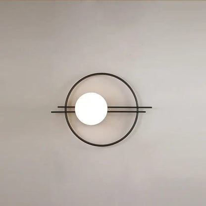 Minimalist black metal DecorBites led G9 wall sconce with a glowing white spherical bulb for living room and bedroom lighting