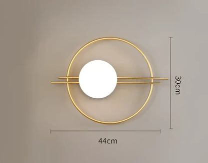 Gold-toned decorbites led g9 wall sconce with central illuminated circle and two horizontal bars for modern minimalist decor