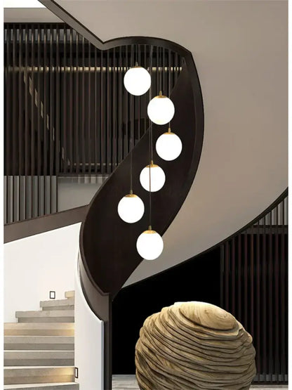 Modern minimalist decorbites led glass ball chandelier with five white glass bulbs and gold chains on black metal frame