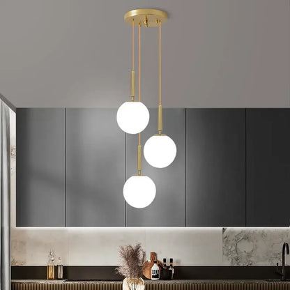 Modern gold-toned DecorBites LED glass ball chandelier with three white spherical LED glass ball bulbs for home decor