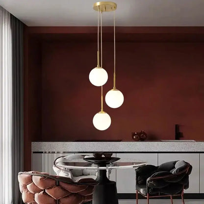 Modern three-bulb decorbites led glass ball chandelier with gold metal fixtures and frosted spheres for dining room lighting