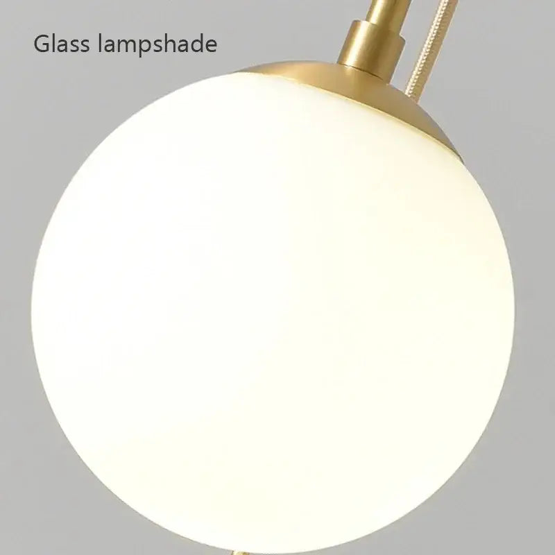 A sleek frosted glass ball lampshade with polished brass fixture in decorbites led glass ball chandelier for dining room