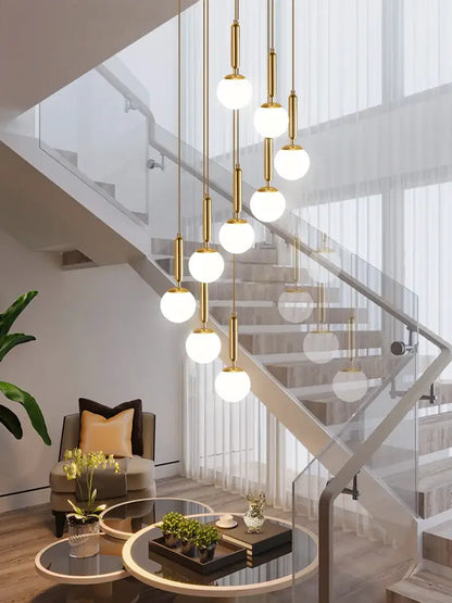 Gold-toned decorbites led glass ball chandelier with spherical white glass shades for modern indoor lighting