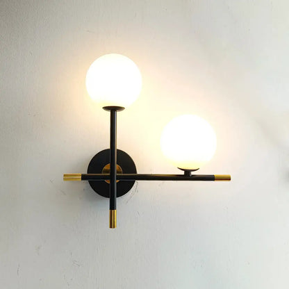Modern black and brass decorbites led glass ball wall lamp with two frosted glass globe shades for bedroom lighting
