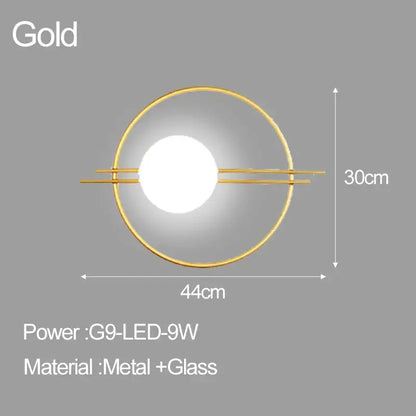 Gold circular wall sconce with central illuminated glass ball and metal frame decorbites led glass for bedroom living room