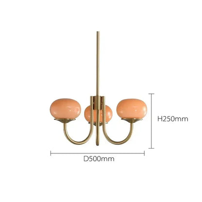 A brass-finished decorbites led glass chandelier with three peach glass balls for elegant home lighting