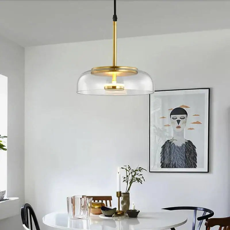 A modern pendant light with a brass-finished rod and clear glass dome from decorbites led glass bowl for home decor