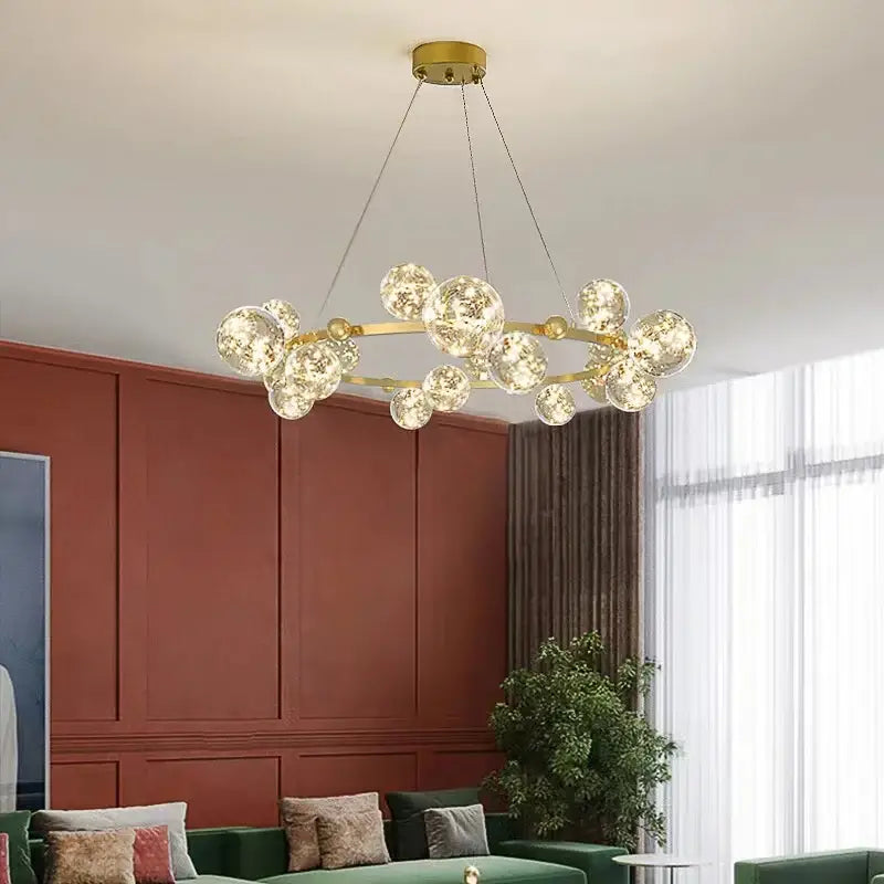 Gold-toned decorbites led glass pendant light with multiple clear bubble-like led glass bulb spheres suspended