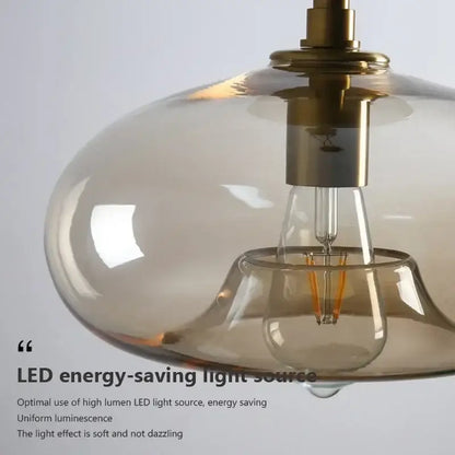 Modern decorbites led glass ceiling light with amber glass shade brass hardware and exposed led filament bulb
