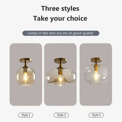 Three modern decorbites led glass ceiling light pendant lamps with brass fixtures and clear and amber spherical shades