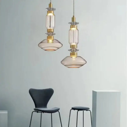 Two elegant DecorBites LED glass chandelier pendant lights with clear amber glass and gold-toned metal accents hang elegantly