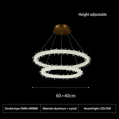 A modern gold-toned decorbites led glass crystal chandelier with two concentric rings and clear crystal accents