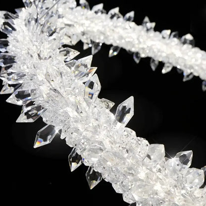 A decorbites led glass crystal chandelier pendant light featuring a clear crystal headband with faceted pointed crystals