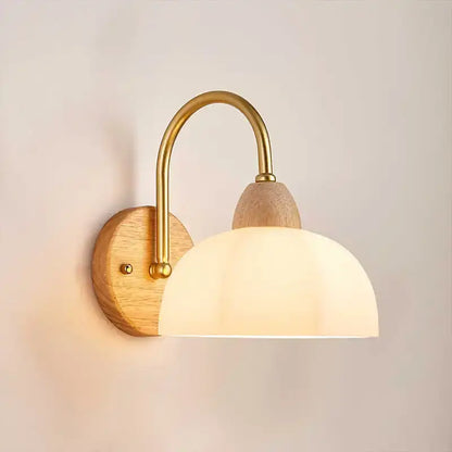 DecorBites™ warm-toned brass and wood wall light fixture with frosted glass dome for modern bedside lighting