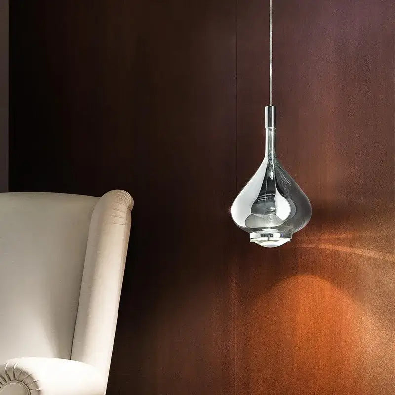 Decorbites led glass pendant chandelier with transparent glass and chrome accents hangs against dark wood wall