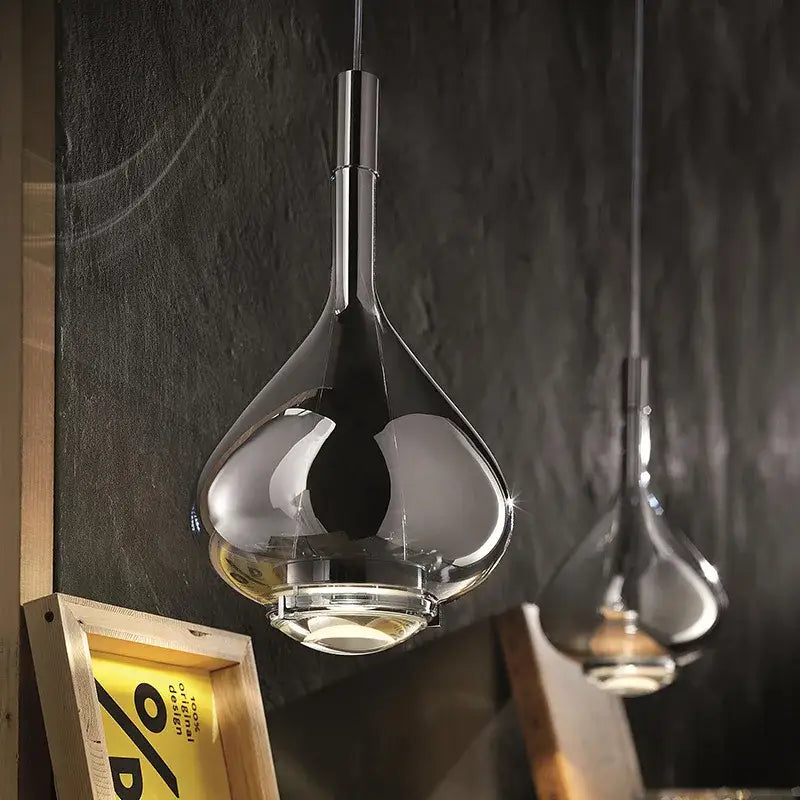 A sleek teardrop-shaped pendant chandelier with polished chrome and clear glass in decorbites led glass design