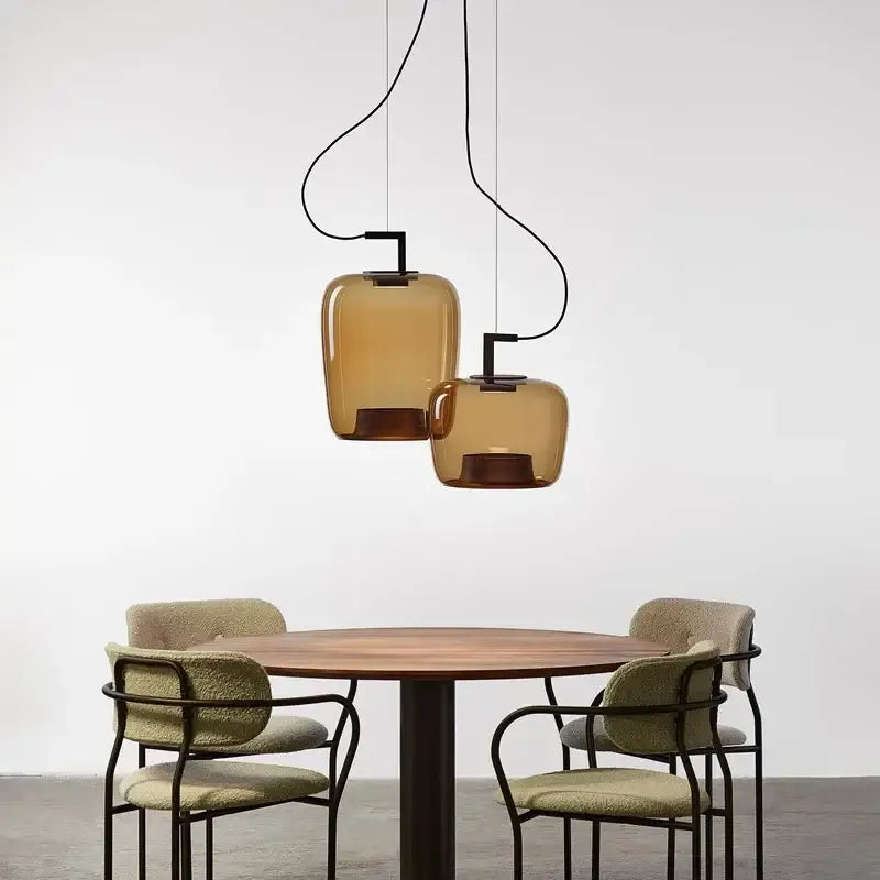 Two amber glass led glass pendant lights with black metal fixtures from decorbites led glass pendant chandelier hang above table