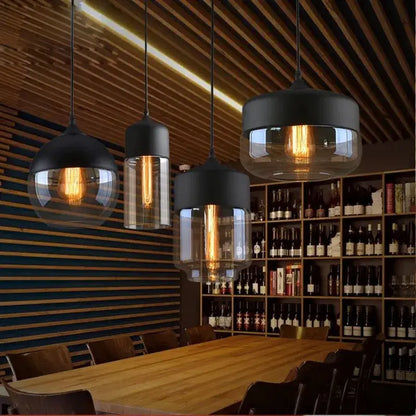 Decorbites led glass black metal pendant lamp with clear shades and exposed filament bulbs above wooden table