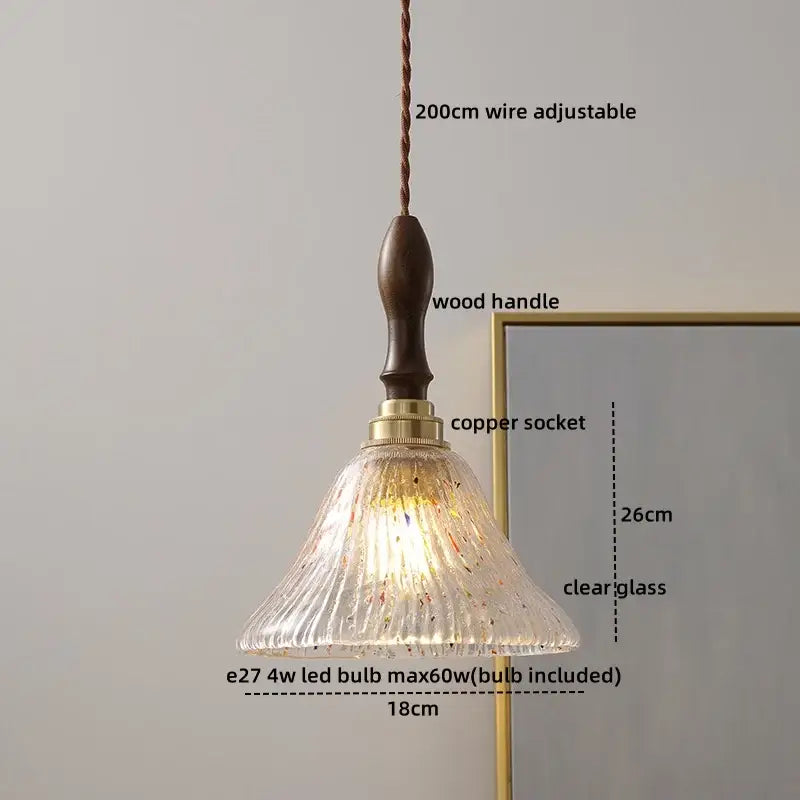 A warm-toned fluted led glass pendant light with speckles by DecorBites suspended from a dark wood handle