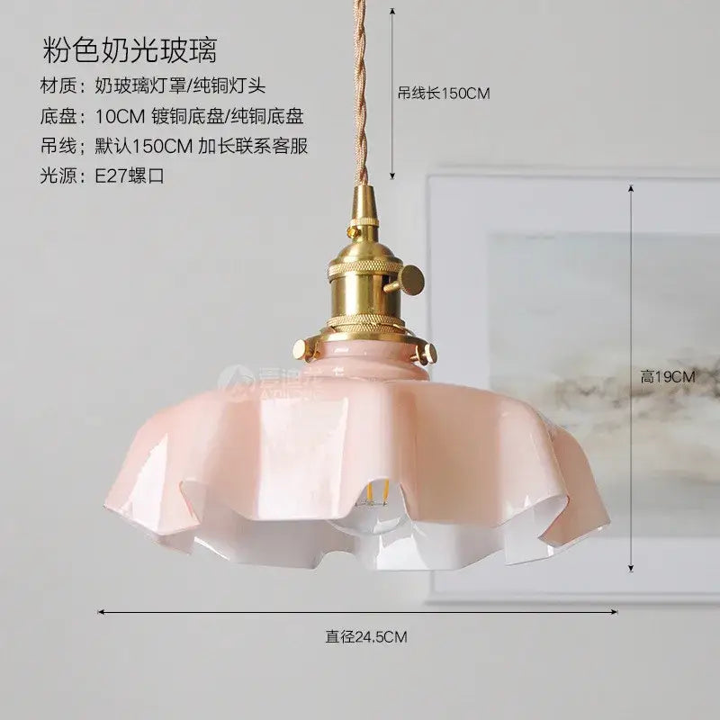 A delicate pink frosted glass decorbites led glass wall lamp with brass fixture and twisted cord for bedroom or living room