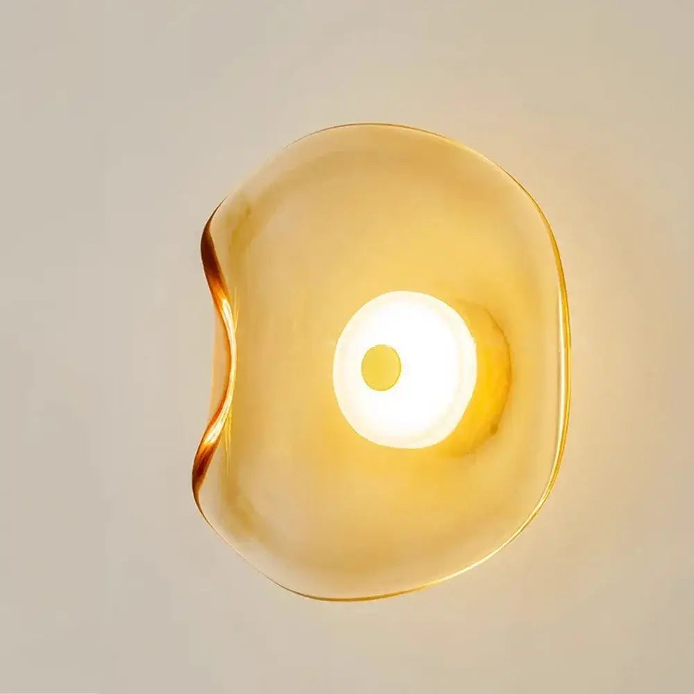 Decorbites™ led glass wall lamp featuring a translucent amber glass wall lamp with a smooth teardrop shape and central light source