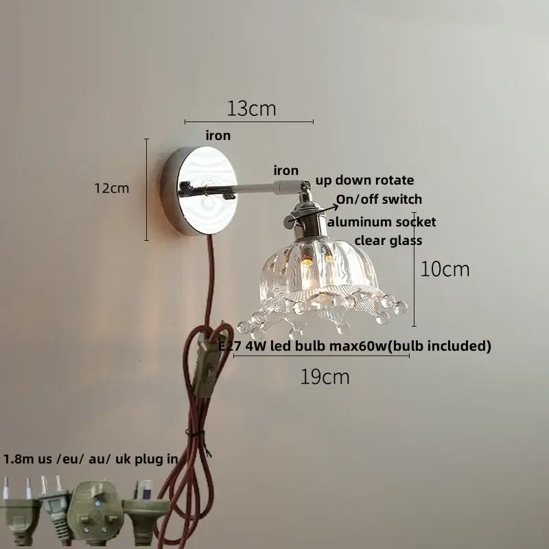 A clear glass decorbites led glass wall light fixture with chrome iron arm and adjustable aluminum socket for bedside use