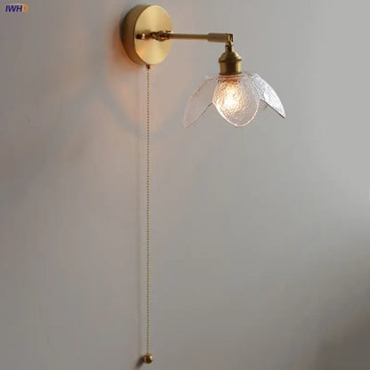 Gold-toned DecorBites™ LED wall light fixture with textured glass flower shade and adjustable pull-chain switch for living room use