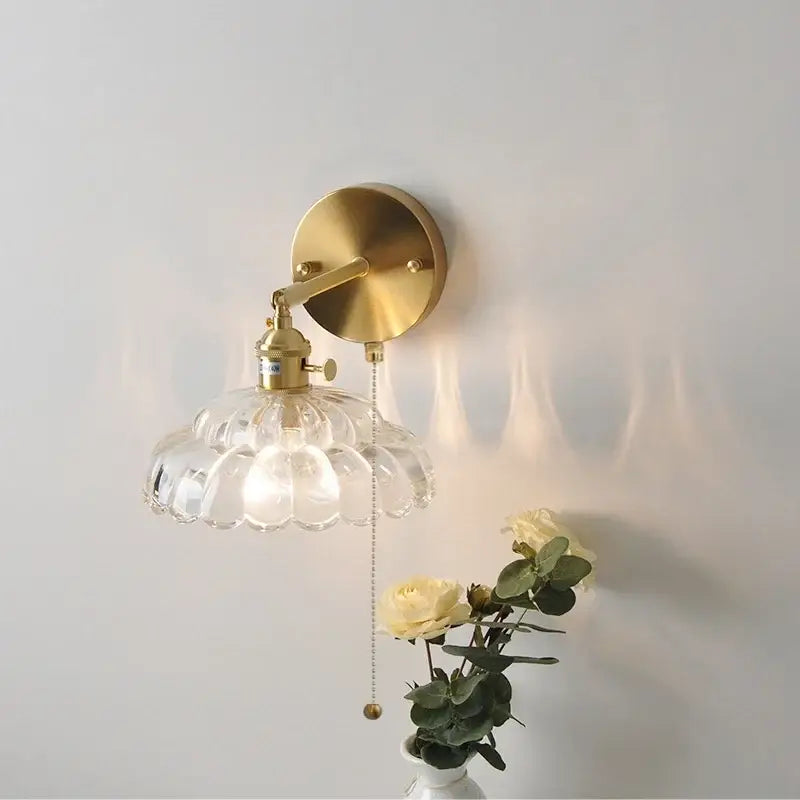 Brass-finished decorbites led glass wall sconce with clear scalloped glass shade and attached pull-chain switch