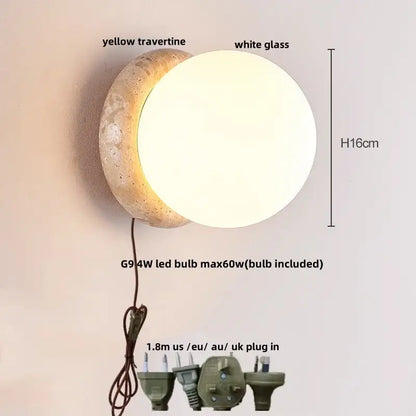 A modern decorbites led glass wall light with textured yellow travertine base and white glass globe with pull chain switch