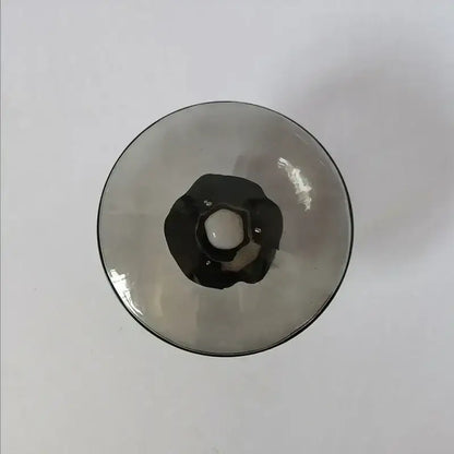 A sleek dark-tinted glass wine goblet with black rim and ornate stem detail for decorbites led glass wall sconce