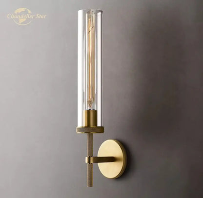 Gold-toned decorbites led glass wall sconce with clear glass cylinder and exposed filament bulb for indoor use