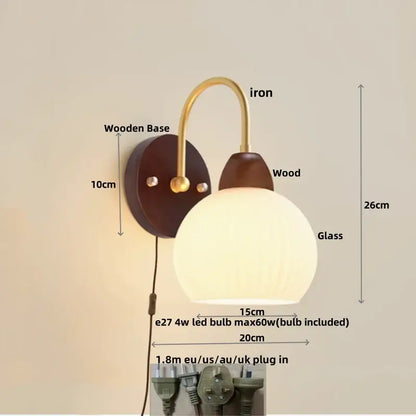 DecorBites led glass wall sconce with a warm spherical glass lamp, brass iron arm, and dark wood base for modern decor