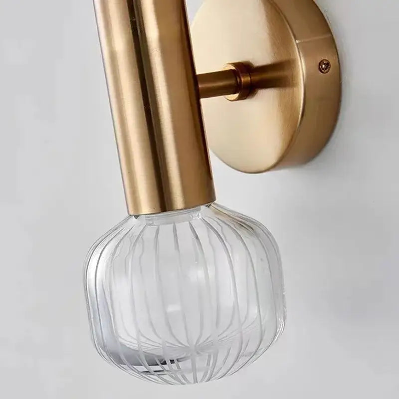 DecorBites™ LED glass wall sconces with brushed gold metal arm and clear ribbed glass globe for home lighting
