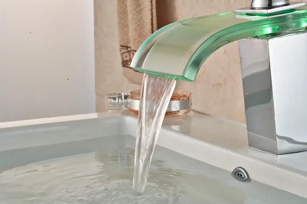 A sleek decorbites led glass basin faucet with translucent green spout and polished chrome base for bathroom use