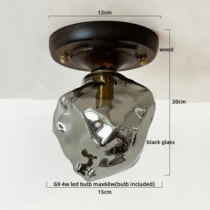 A sleek black glass ceiling light with dark wood mount and brass accents by DecorBites led glass wood for living room