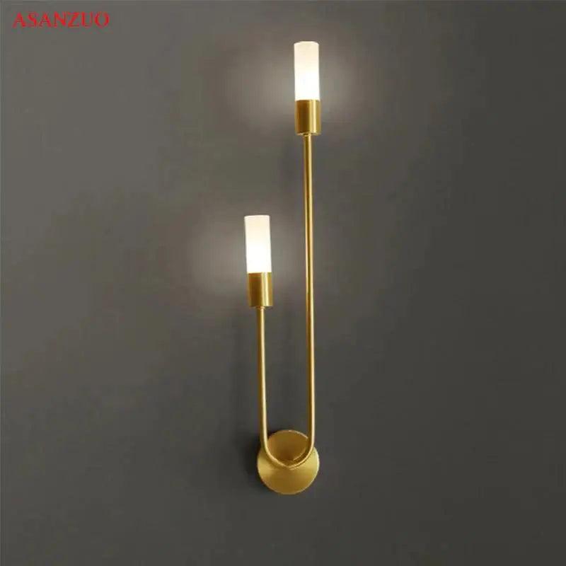 Decorbites led gold candlestick wall light with two vertical cylindrical fixtures and sleek curved metal frame for indoor decor