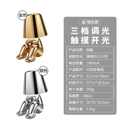 Golden boy table lamp by decorbites led golden featuring a glossy resin seated figure design with rechargeable led light