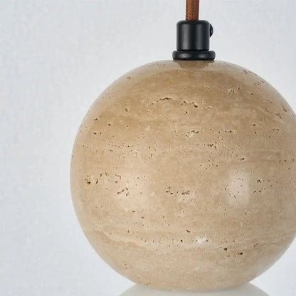 Beige spherical stone pendant light with black metal fixture and brown leather cord in decorbites led gourd pendant design