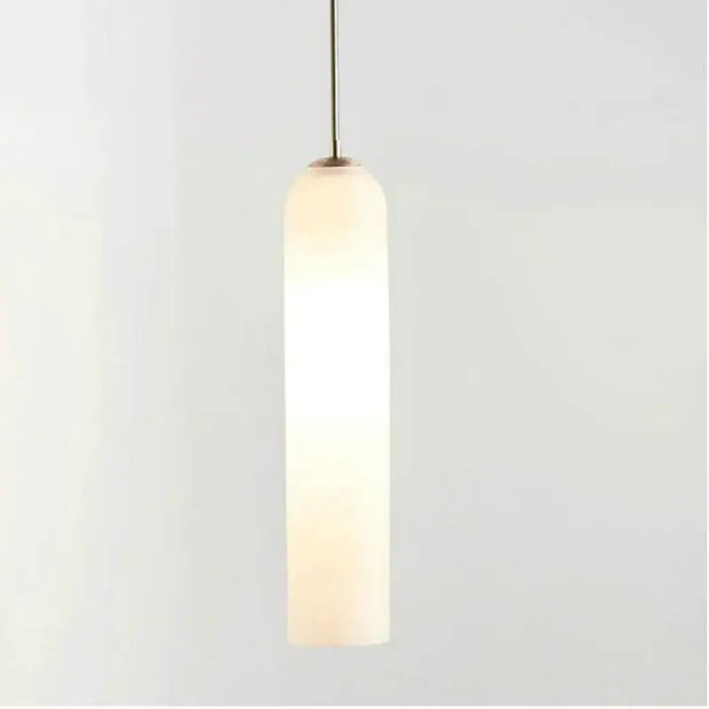 A sleek decorbites led green glass pendant light with a frosted glass shade and brass stem for kitchen bar decor