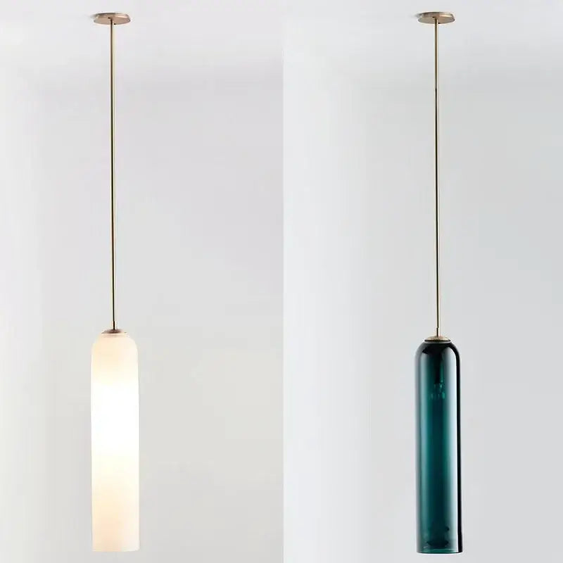 Two minimalist pendant lights with frosted white and deep teal led green glass shades from decorbites led green collection